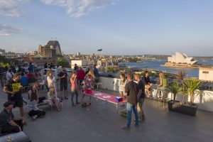 people playing ping ong on roof overlooking Syndey harbour