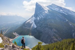 traveller in nature looking towards mountain